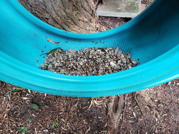 how to make a cute diy tire swing planter for your garden gnomes, Adding gravel to the tire