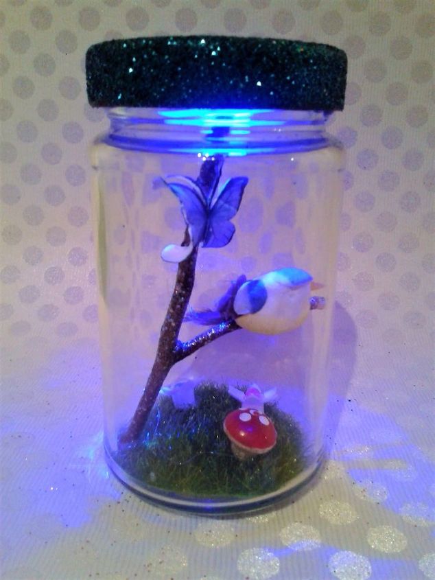 planter in jar garnished with a fairy garden led