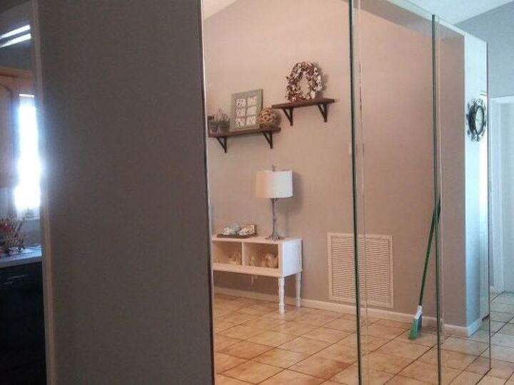 q how can i hide or get rid of this 70 s mirror in my living room