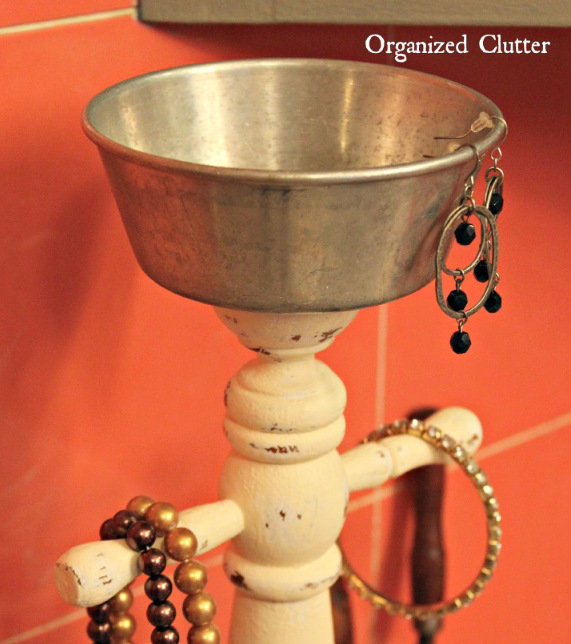 s 30 creative ways to repurpose baking pans, Organize jewelry with a pan on a stand