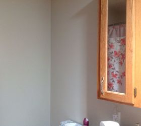 q how to decorate wall space above toilet beside honey oak vanity