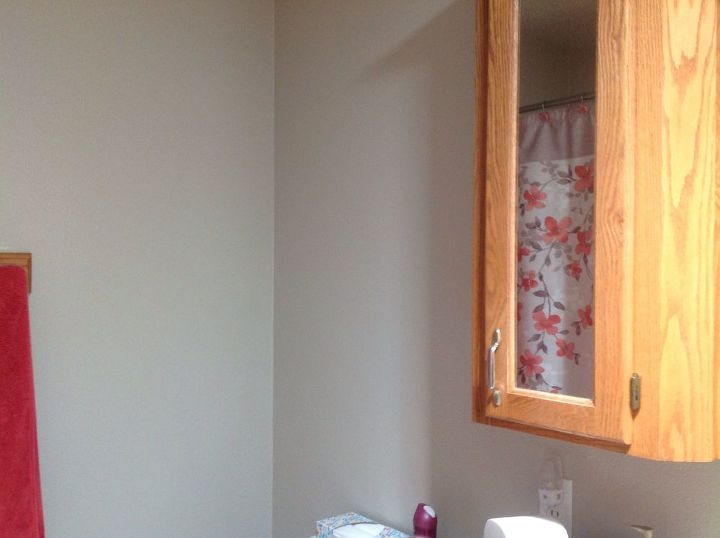 q how to decorate wall space above toilet beside honey oak vanity