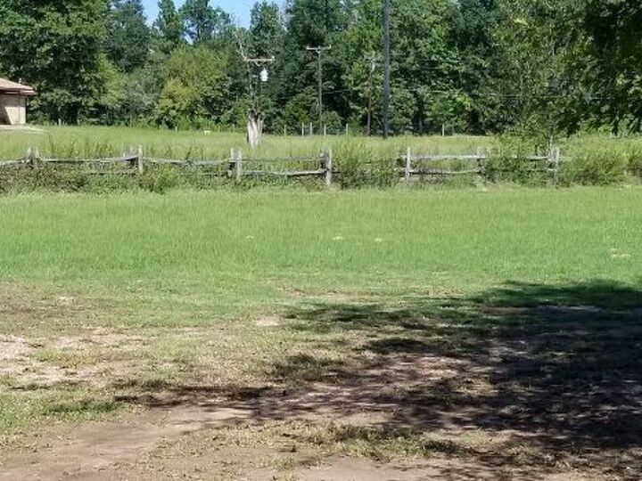 q weeds and grass under the fence