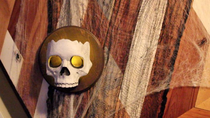 s 17 halloween decorations that ll make your neighbors giggle, DIY Dollar Store Skull Sconces
