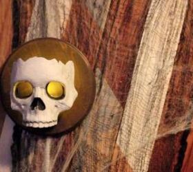 s 17 halloween decorations that ll make your neighbors giggle, DIY Dollar Store skull sconces