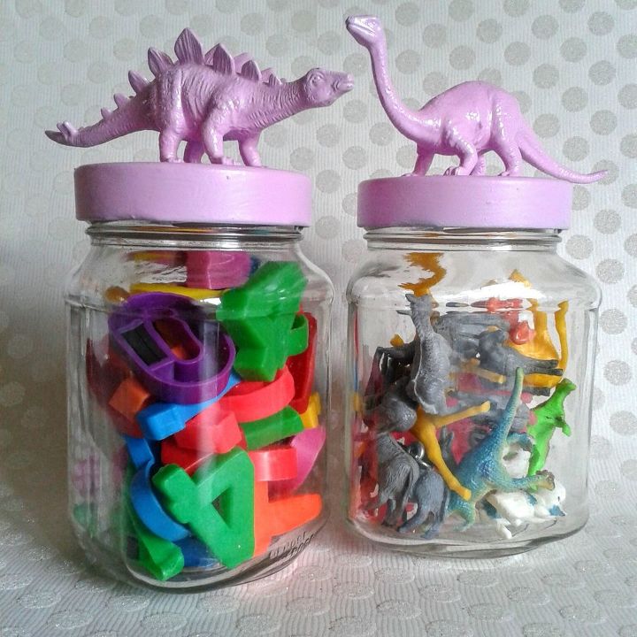 two silver dinosaurs on the lids of decorative jars