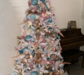 christmas tree decorating blue pink and gold ornaments