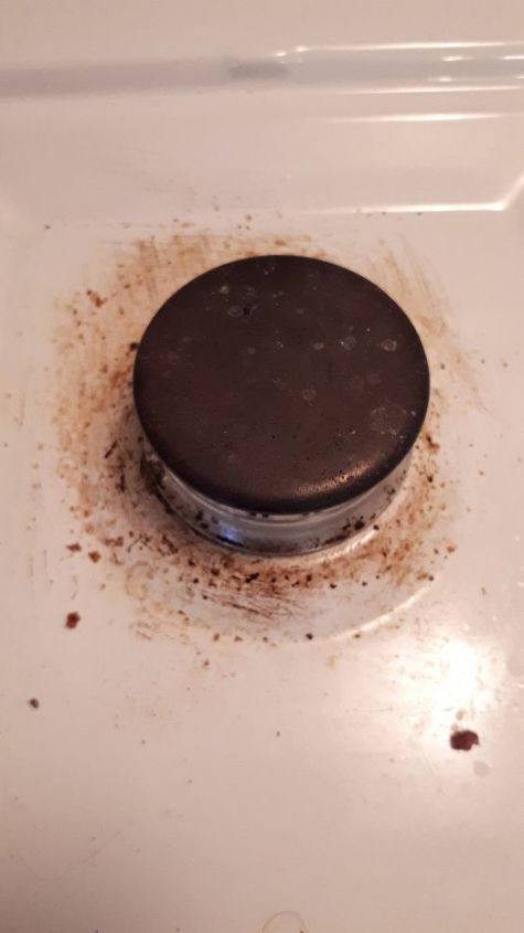 q how do i clean the surface of a gas stove surrounding the burners