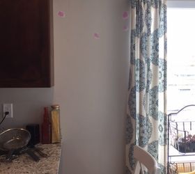 The clever reason this weary mom hung curtain rods on her kitchen wall