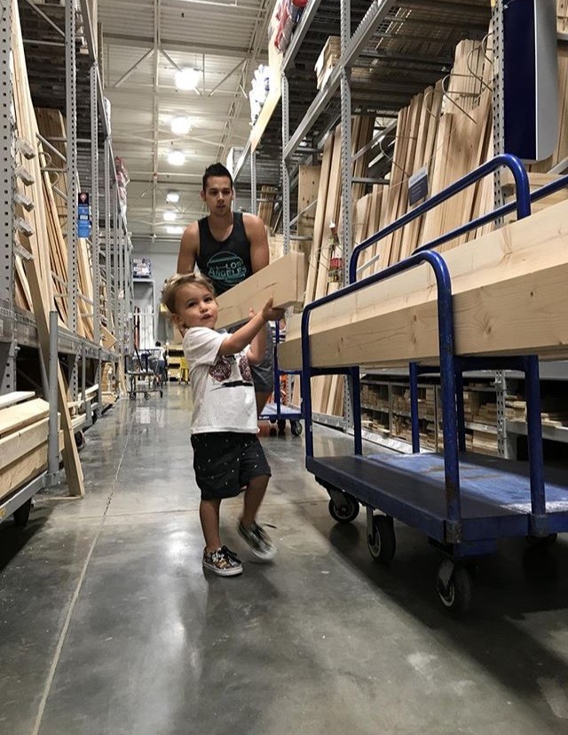 how to make a diy sliding barn door console inspired by ana white, Little helper carrying the plywood