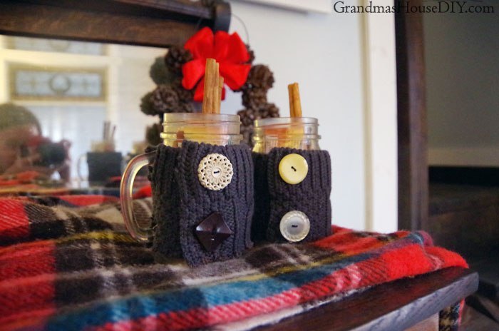 apple cider in a jar with a sweater koozie