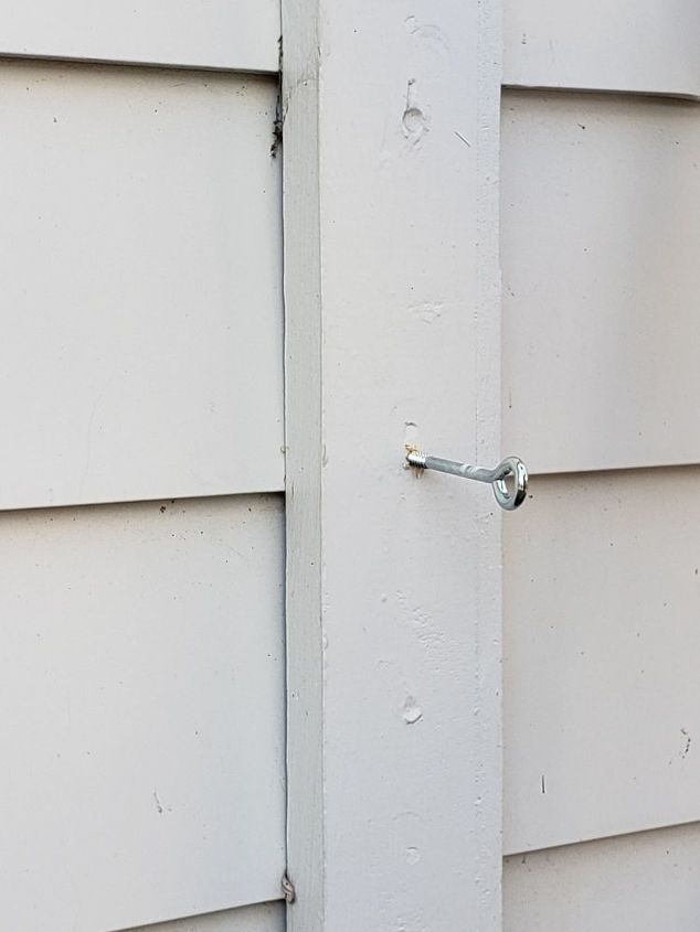 how to use logs as edging for plants make a wall trellis, Attaching eye screws to the wood