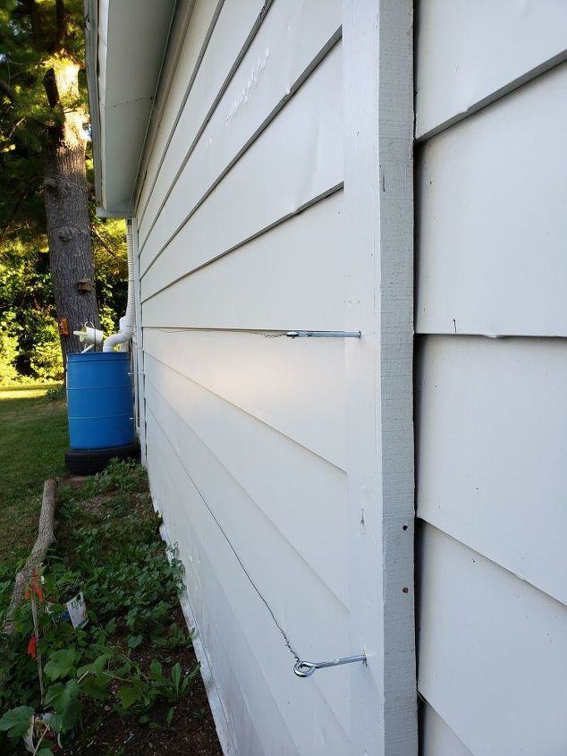 how to use logs as edging for plants make a wall trellis, Making rows of wire for the trellis