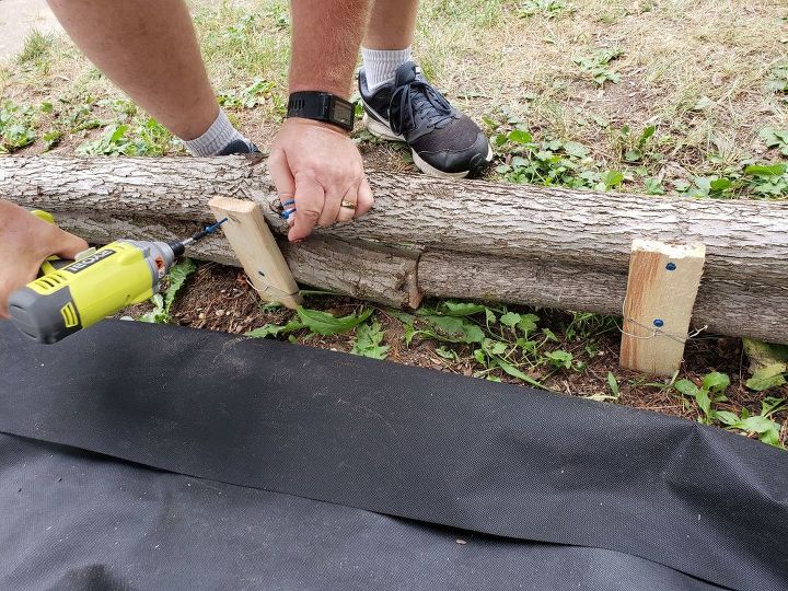 how to use logs as edging for plants make a wall trellis, Stacking and screwing the logs in place