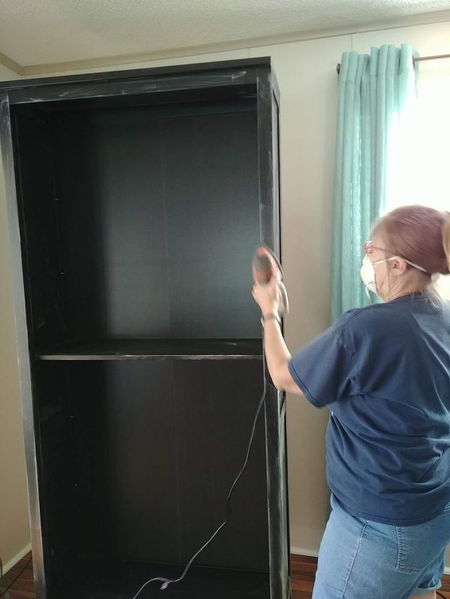 free paint gives new life to ikea hemnes bookcases, My sister is lightly sanding the surface