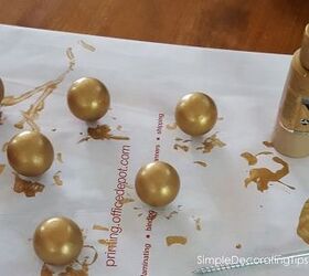 She paints 6 wood balls gold for this showstopping table makeover