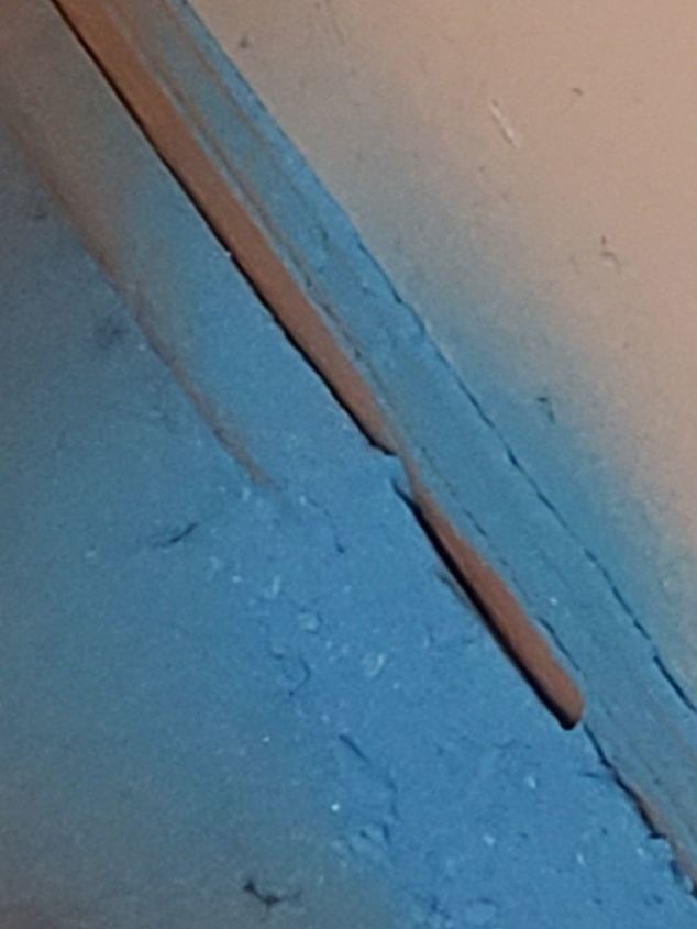 what is this blue powder coming from around baseboards in my kitchen