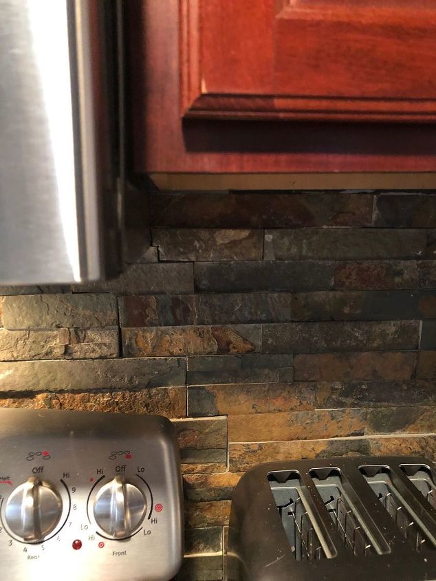 how to lighten a dark faux rock backsplash