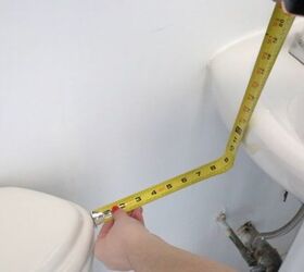 She measures the space next to her toilet for a brilliant storage idea