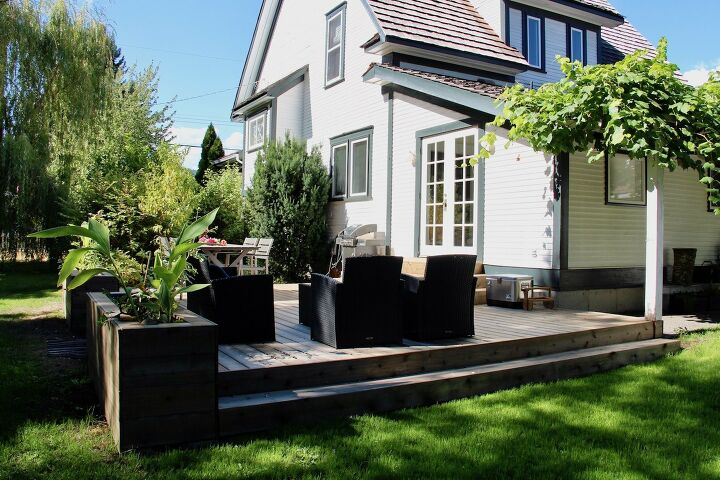 diy raised garden bed ideas to transform your garden space, Decking With Built In Raised Bed Planters