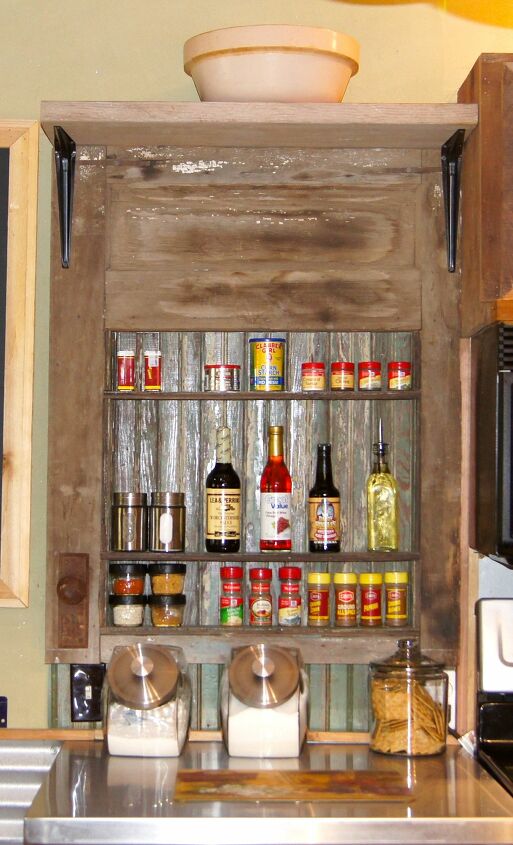 16 diy spice rack ideas to reorganize your kitchen storage, Weathered Door Becomes a Rustic Spice Rack