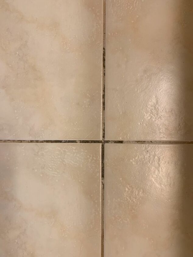 q cleaning dirty floor tile grout