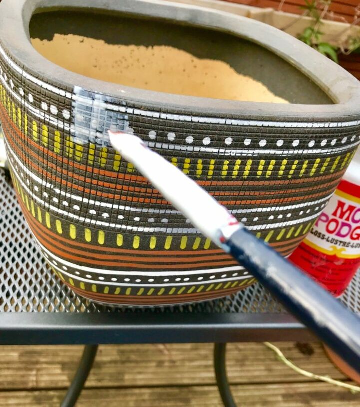 how to create a tribal look planter with paint pens, Applying sealant to surface