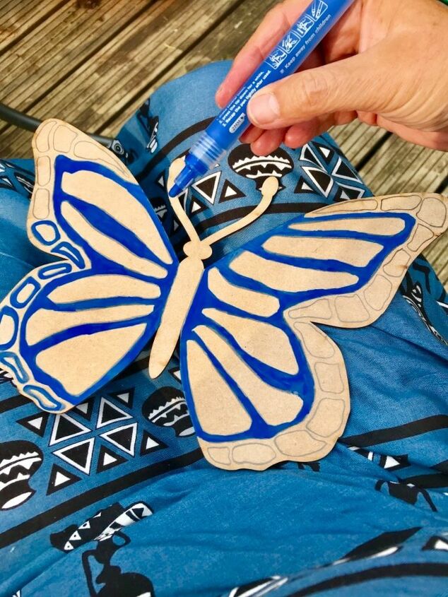 create a big beautiful butterfly for your garden fence with paint pens, Using acrylic paint pens to add colour