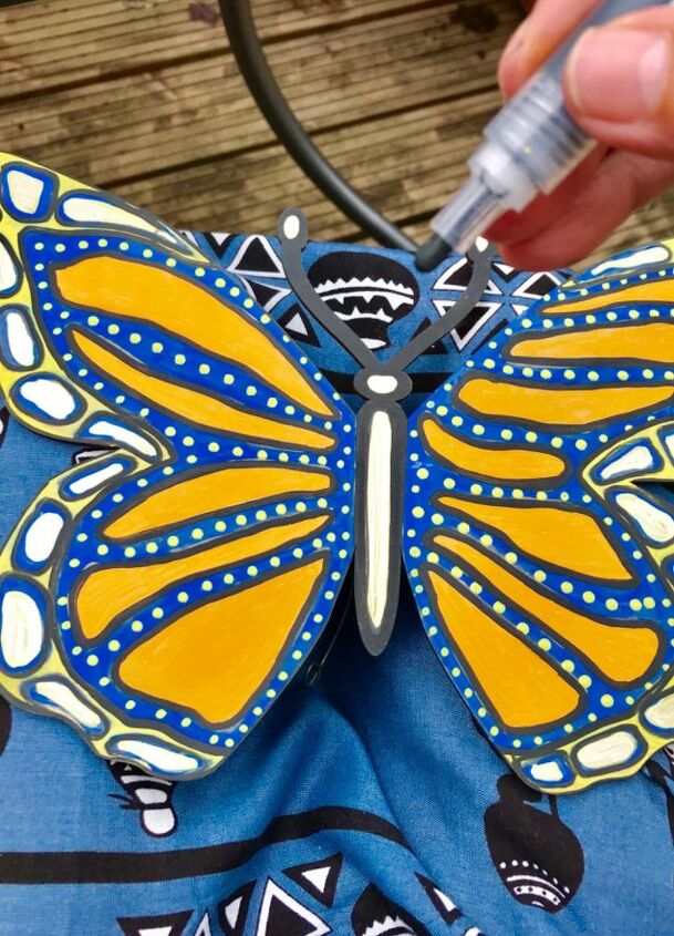 create a big beautiful butterfly for your garden fence with paint pens, Outline in black and add dots texture