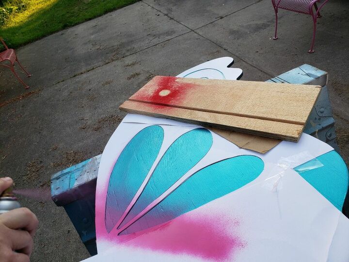 how to make life size fairy wings for a cute garden feature, Spray painting with the wing stencil