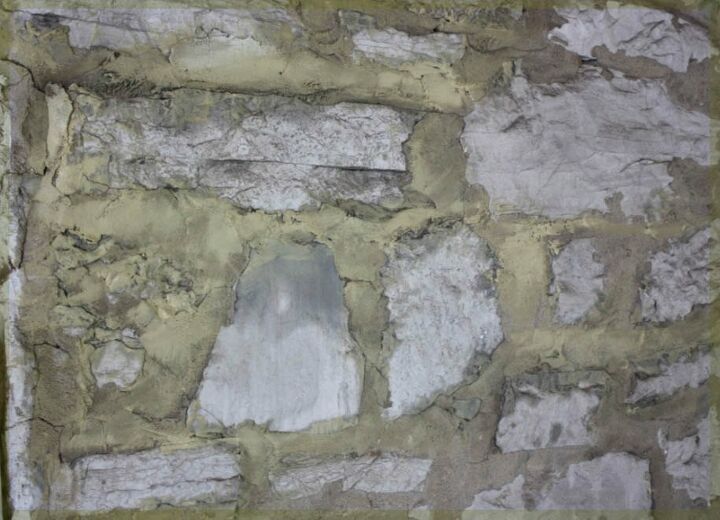 whitewashing a stone wall with diluted chalk paint