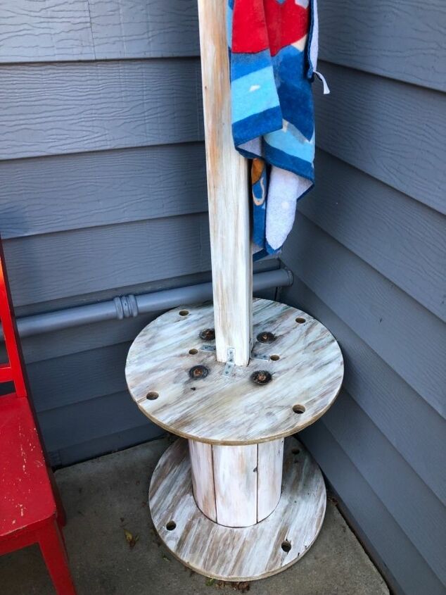 repurposed wooden spool to towel and table rack, This area holds personal items or cold drinks