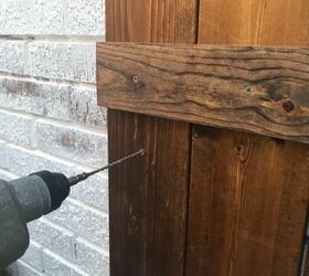 how to hang wood shutters on brick, drilling pilot holes into brick behind wood shutters