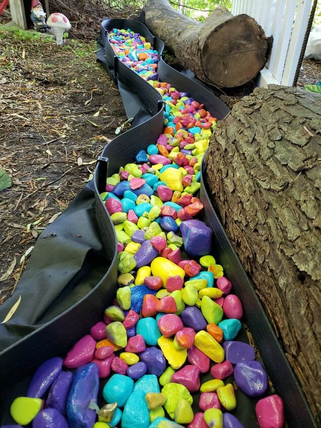 how to make diy rainbow river rocks for a magical yard decor idea, Rainbow rock landscaping