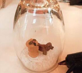 adorable diy wine glass snow globes, Put a fine layer of glue around the base