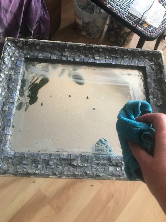 how to use up your broken china to decorate a mirror frame, Wipe off excess grout