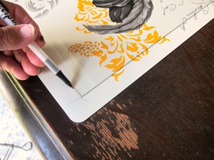 frame a rooster placemat and hang it on the wall
