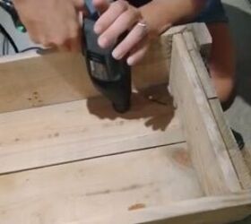 how to build a coffee table ottoman out of an ammunition crate, Screw the legs to the crate
