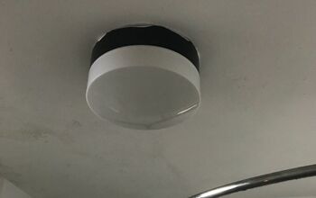 How do I replace the bulb in this enclosed bathroom ceiling light?