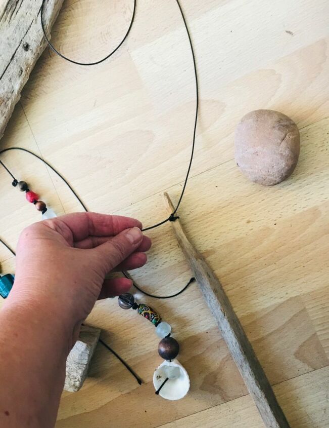 how to make a beautiful piece of wall art from beach finds, Tie cord to the Driftwood