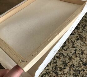Pull a dollar store canvas off its wooden frame for this super simple and beautiful countertop idea