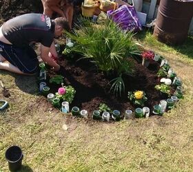 how to use your old glass bottles to create nice flower bed border, Adding plants