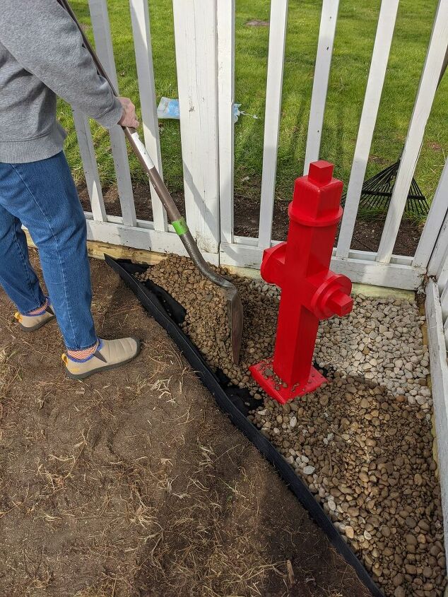how to cheaply easily make a diy fire hydrant for your doggy, Adding rock around the DIY fire hydrant