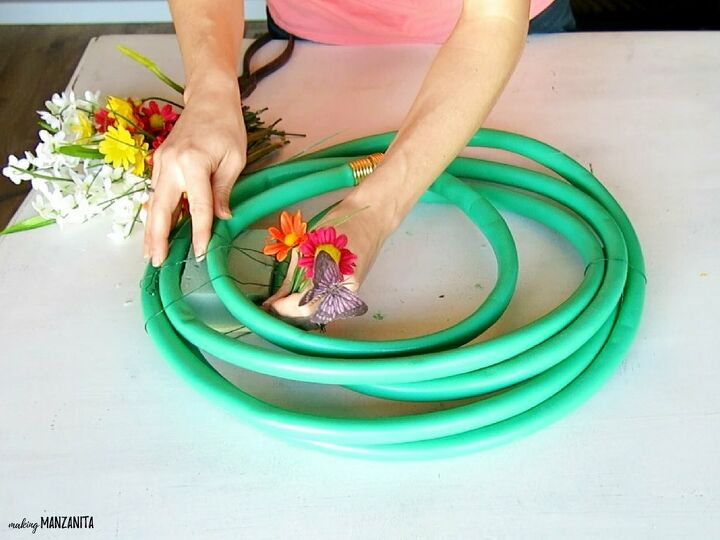 13 unique ways to make over your porch in time for summer, Make a wreath with a garden hose