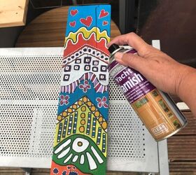 how to make some colourful yard art with a plank of wood, Spray varnish