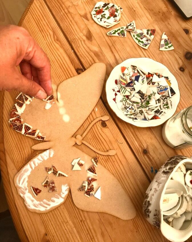 how to transform broken crockery into a beautiful piece of yard art, Stick the tesserae on to base