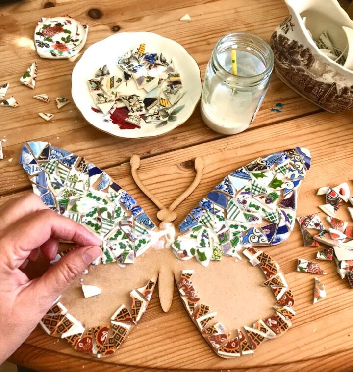 how to transform broken crockery into a beautiful piece of yard art, Filling in with broken china
