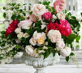 create a flower arrangement with roses and foliage from the garden
