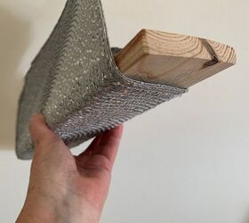She folds a place mat around a board to create one-of-a-kind wall storage