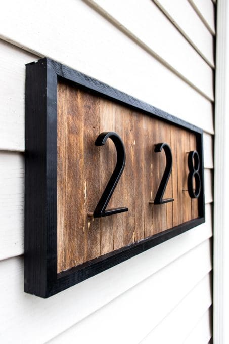 9 sleek house number ideas that ll turn heads on your block, Lay wood shims on a piece of plywood to get this beautiful textured look